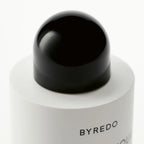 Close-up of a Byredo rose of no man's land body lotion with a black cap on a white background