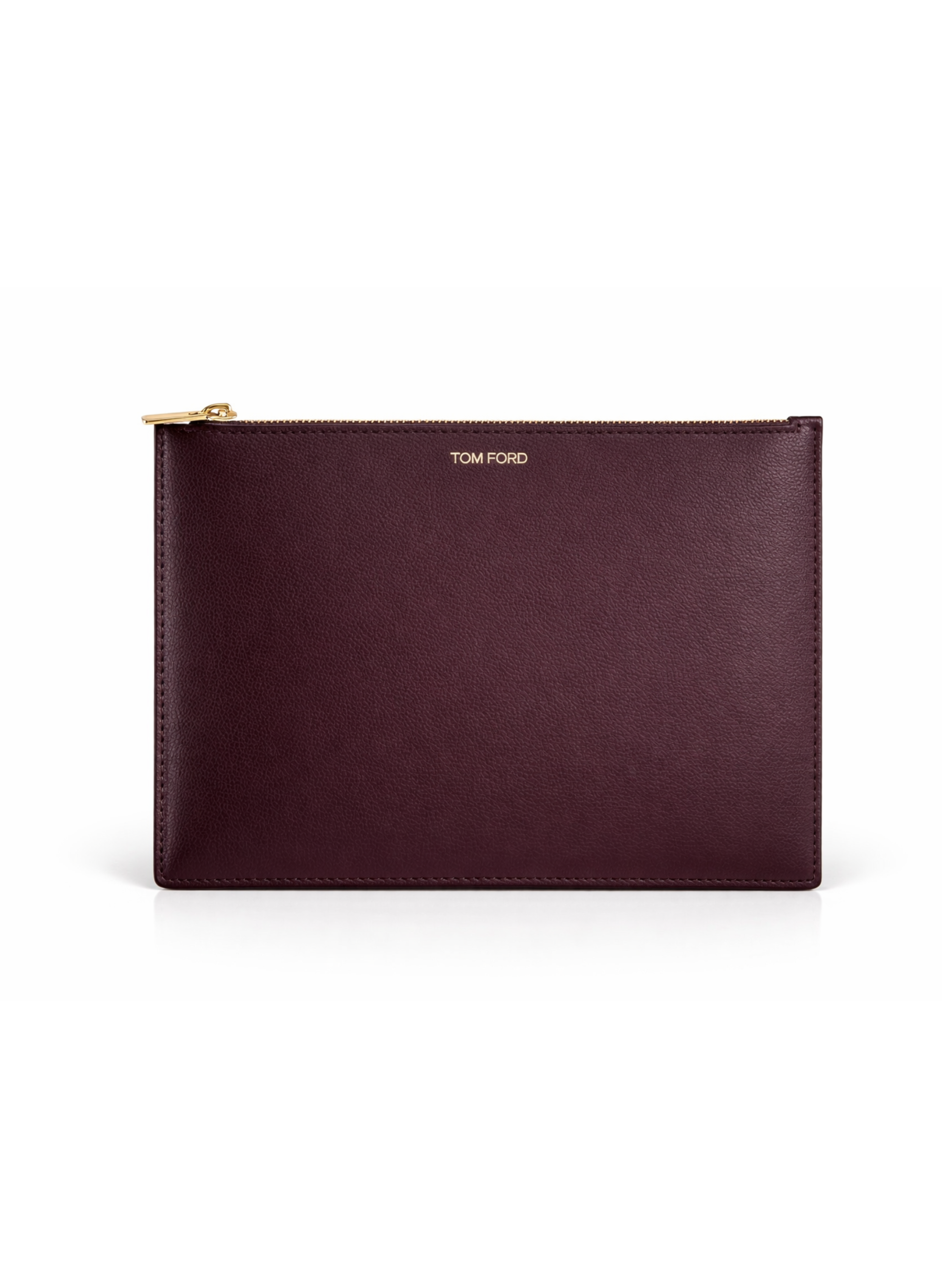 Tom Ford Cosmetics Bag Burgundy leather pouch with gold zipper and 'Tom Ford' branding on a white background