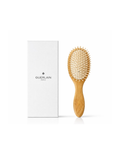 Guerlain wooden hair brush, big size, with original white Guerlain box on a white background
