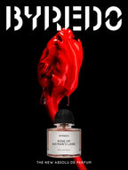 Byredo perfume bottle with a red rose on a black background