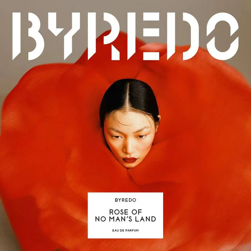 Byredo Rose of No Man's Land perfume packaging with a red flower and a person partially hidden behind it.