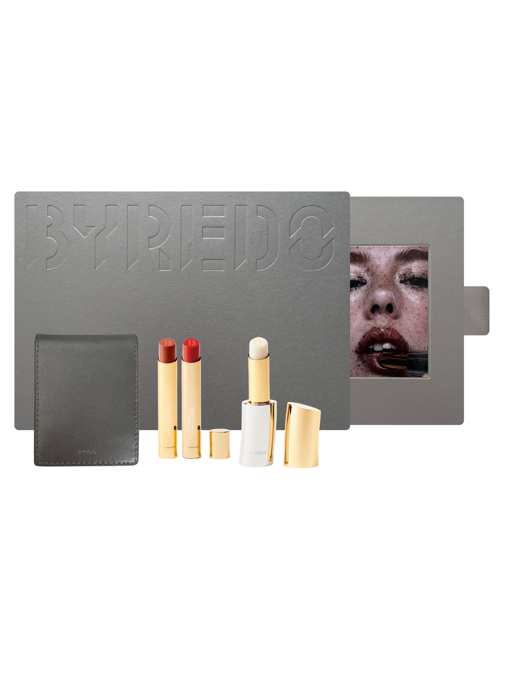 Byredo makeup set with lipsticks and a compact mirror on a white background