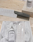 Maison Margiela comb and replica bottle on a rock surface