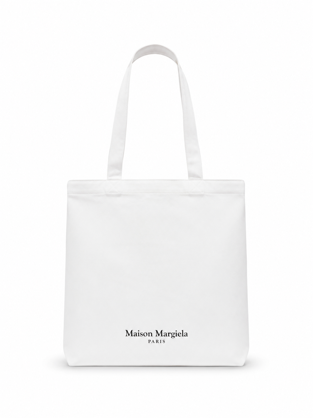 A white canvas tote bag with long handles and the black printed text 'Maison Margiela PARIS' near the bottom center, shown on a clean white background.