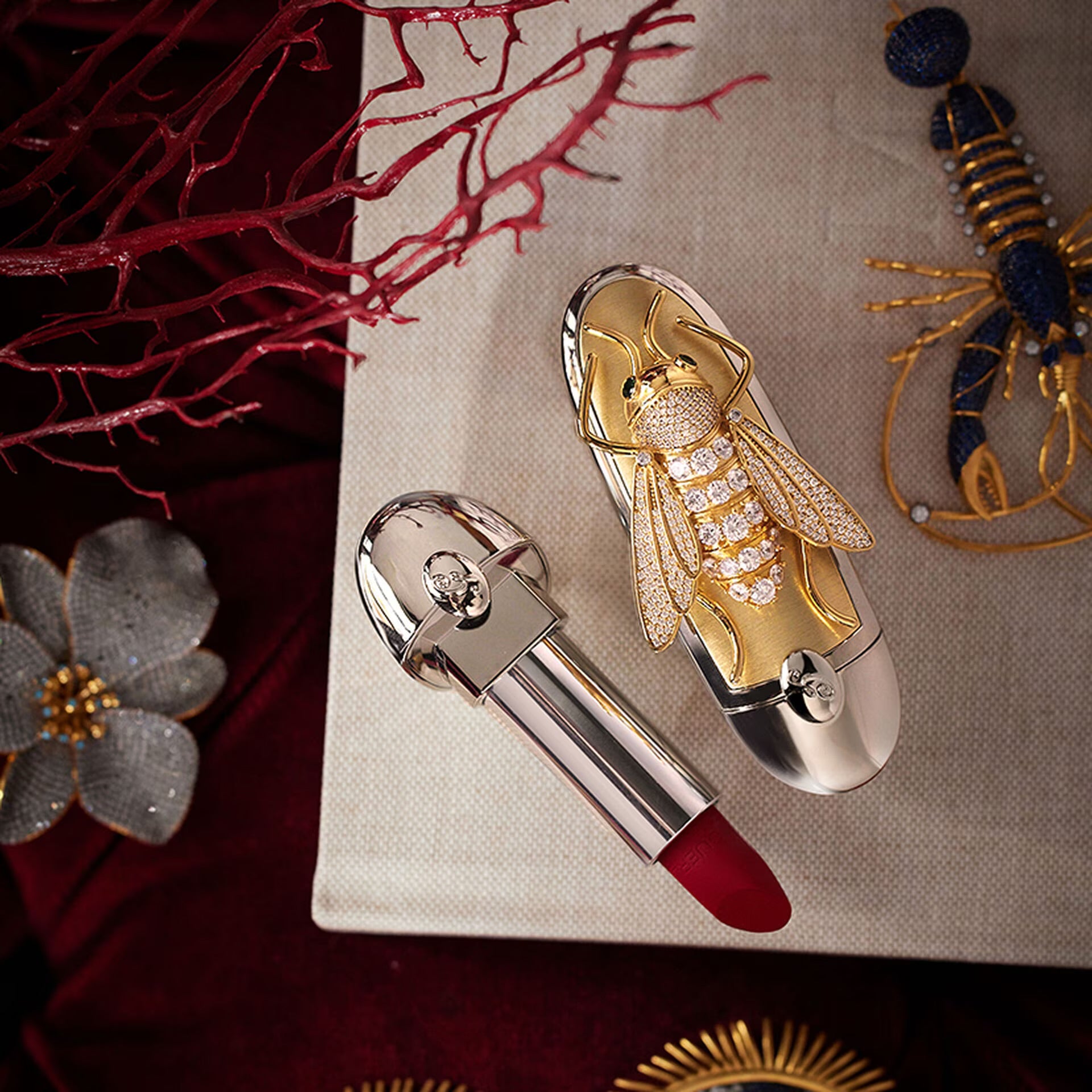 Luxury lipstick with decorative cap on a textured surface