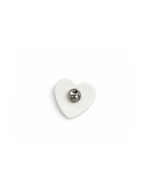 Diptyque porcelain heart brooch, limited edition, white ceramic with a central metallic component on a white background