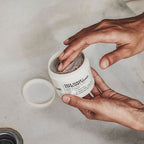 le labo Person using a face scrub exfoliating wash with a marble background