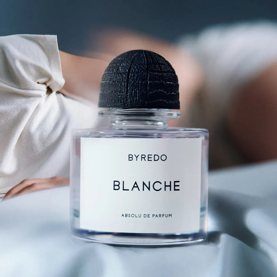 Byredo Blanche perfume bottle with a blurred person in the background