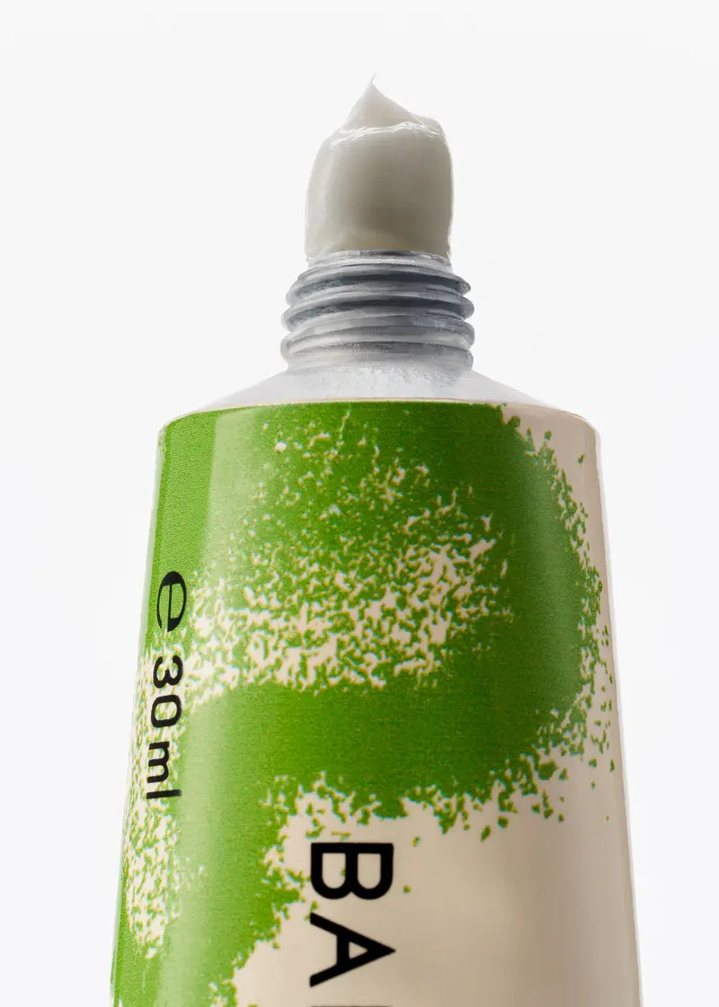 Tube of cream with green label and white cap on a white background, byredo bal dafrique hand cream, tbilisi, georgia