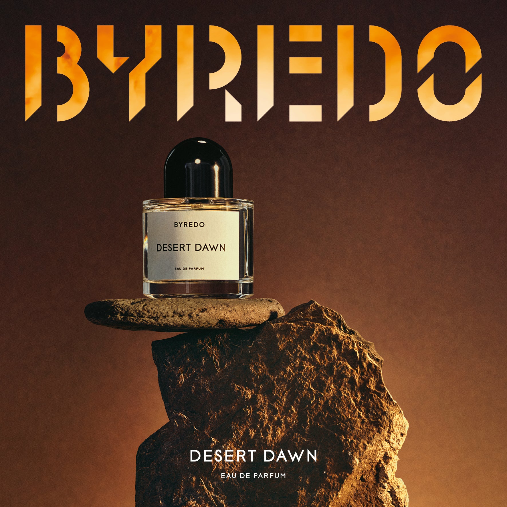 Byredo Desert Dawn perfume bottle on a rock with Byredo logo above