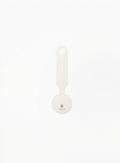 Front view of GUERLAIN white luggage tag featuring Golden bee logo and brand name Guerlain Paris on a clean light background.