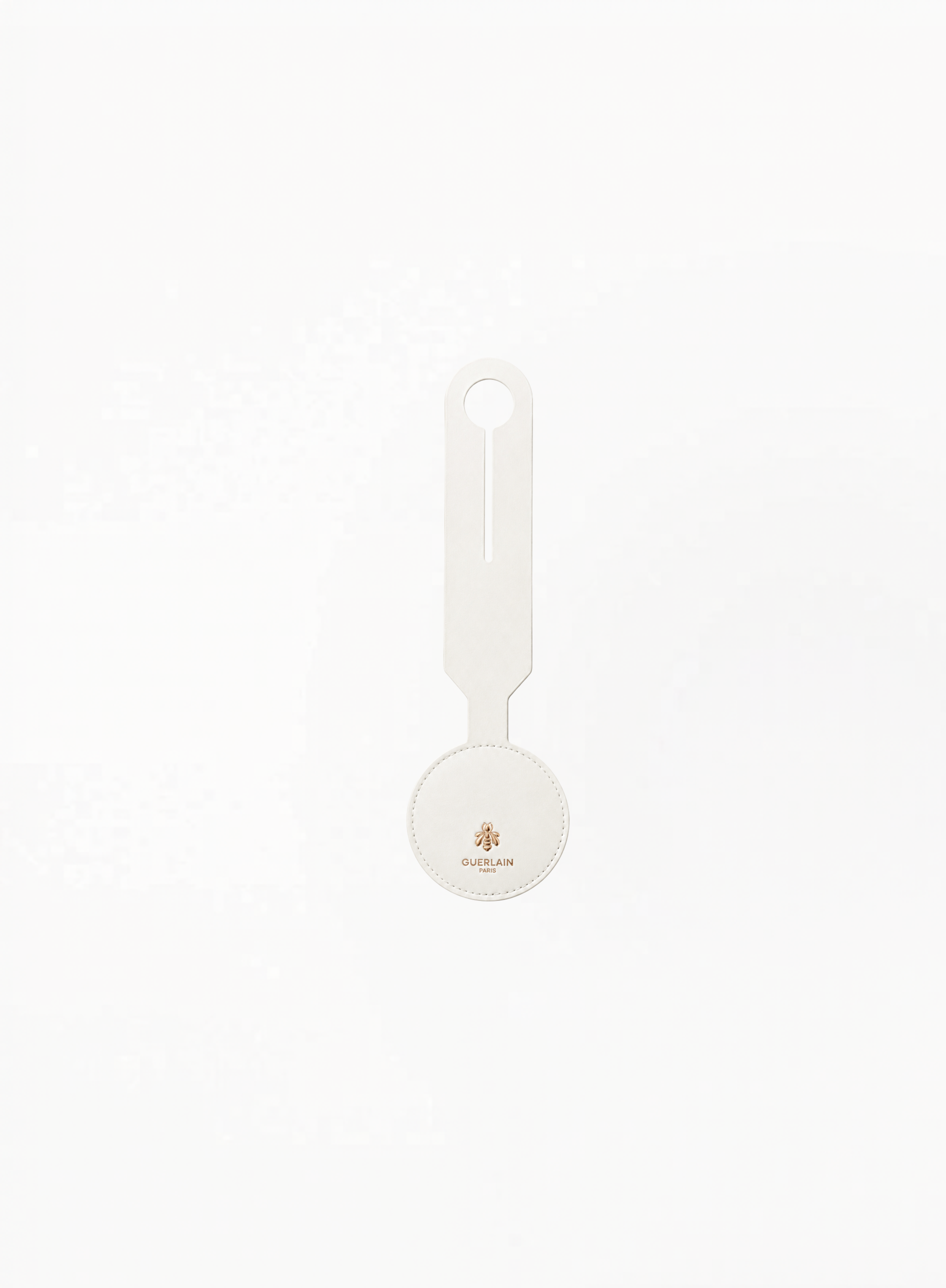 Front view of GUERLAIN white luggage tag featuring Golden bee logo and brand name Guerlain Paris on a clean light background.