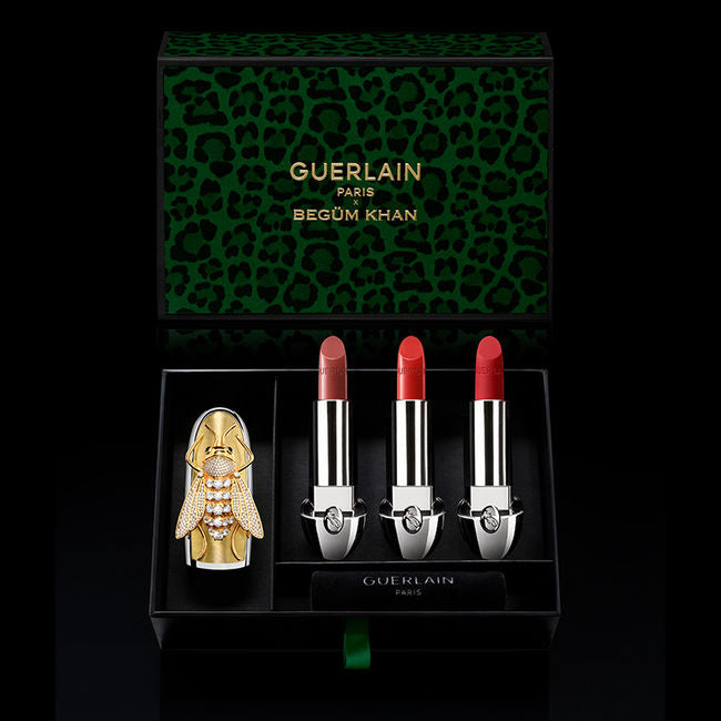 Guerlain lipstick set with decorative case and leopard print box on a black background
