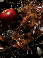 Red apple, apple brandy splash, ice, and oak wood capturing the fresh, boozy inspiration behind KILIAN Apple Brandy on the Rocks Eau de Parfum