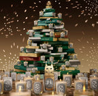 Stack of Diptyque candles arranged in a decorative display with a warm glow.