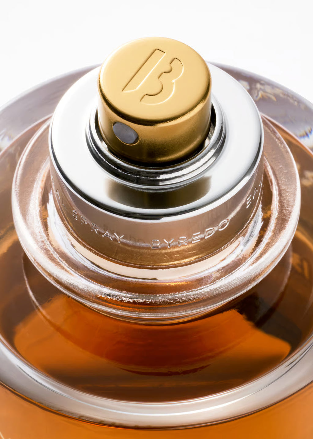 BYREDO Vanille Antique Extrait de Parfum 70ML Close-up of a perfume bottle with a gold cap and clear glass body.