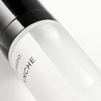 Close-up detail of a BYREDO Body Mist bottle featuring the minimalist label and glossy black cap on a clean light background.