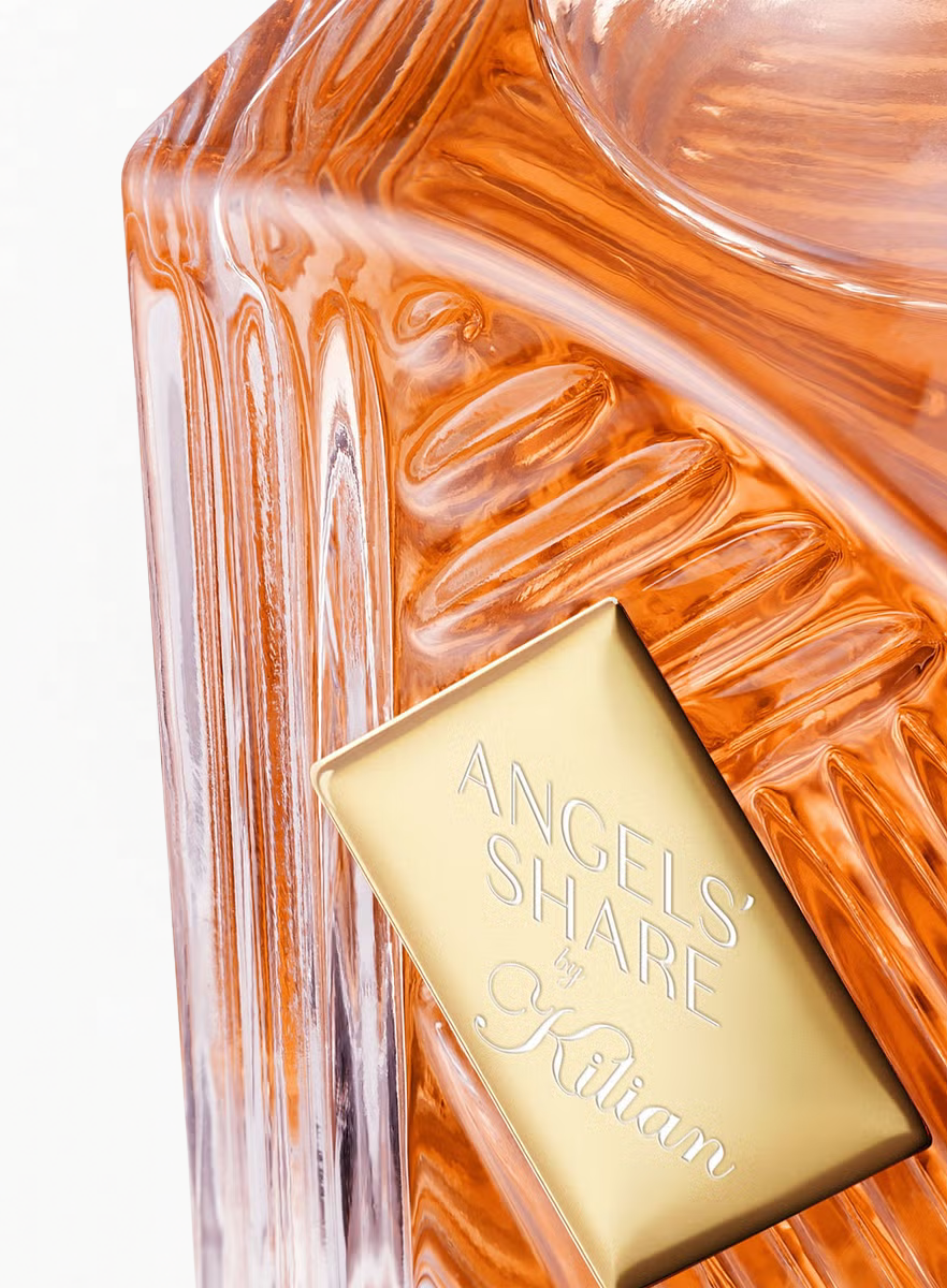 Close-up of the KILIAN Angels’ Share Eau de Parfum bottle showcasing the signature gold plaque and sculpted glass details