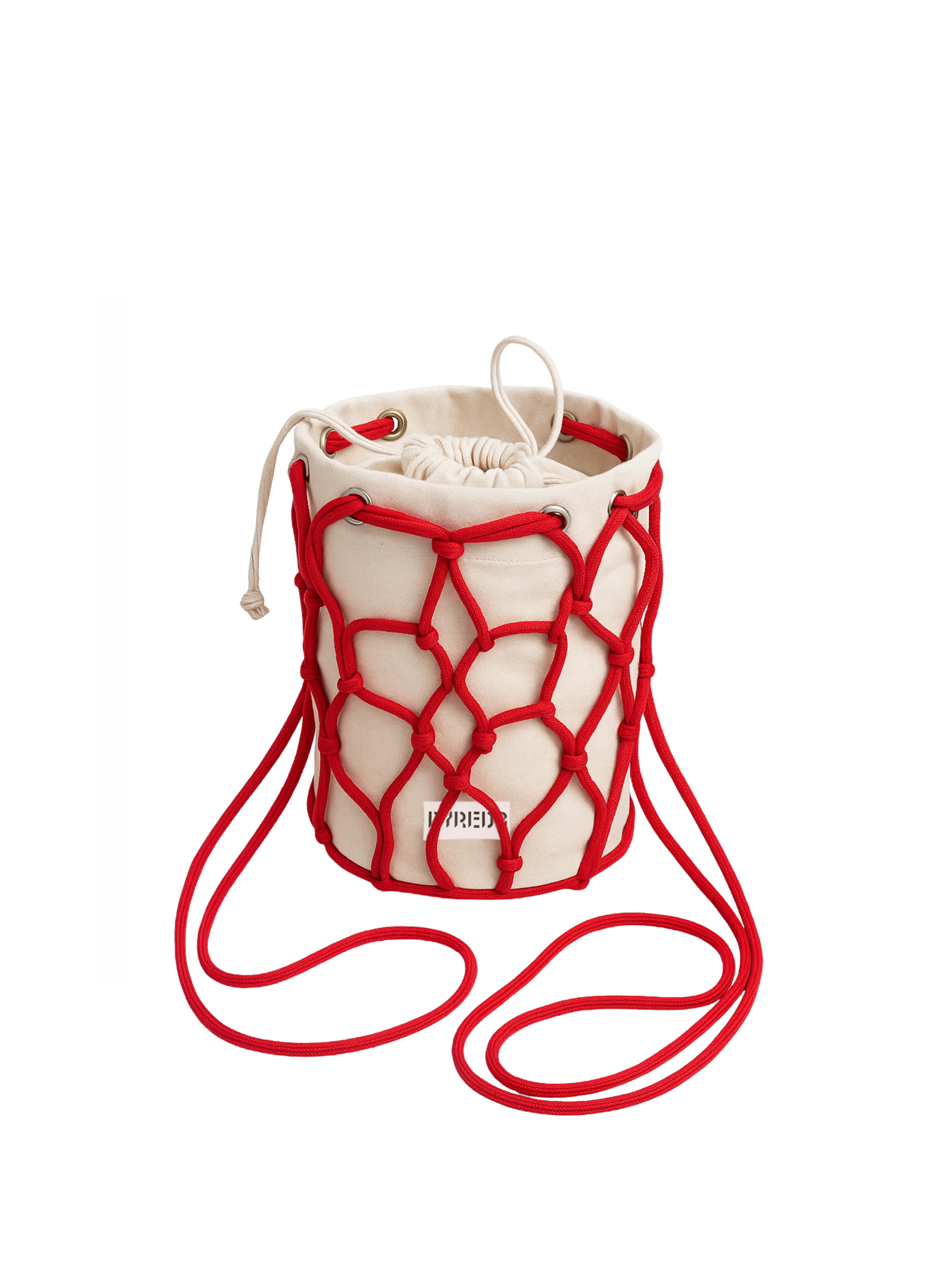 It's a small, cylindrical bucket bag made of a natural, light-colored (likely canvas or linen) fabric. It's encased in a vibrant red macrame-style netting, which also forms the shoulder strap. The bag has a drawstring closure at the top, also in the same light-colored fabric. A small, partially visible label in red text is on the front of the bag, which appears to say "BYREDO"