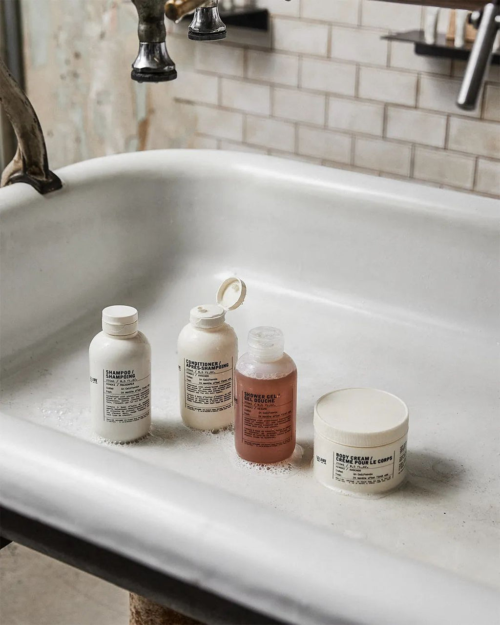 le labo store Four bottles of different sizes on a white sink