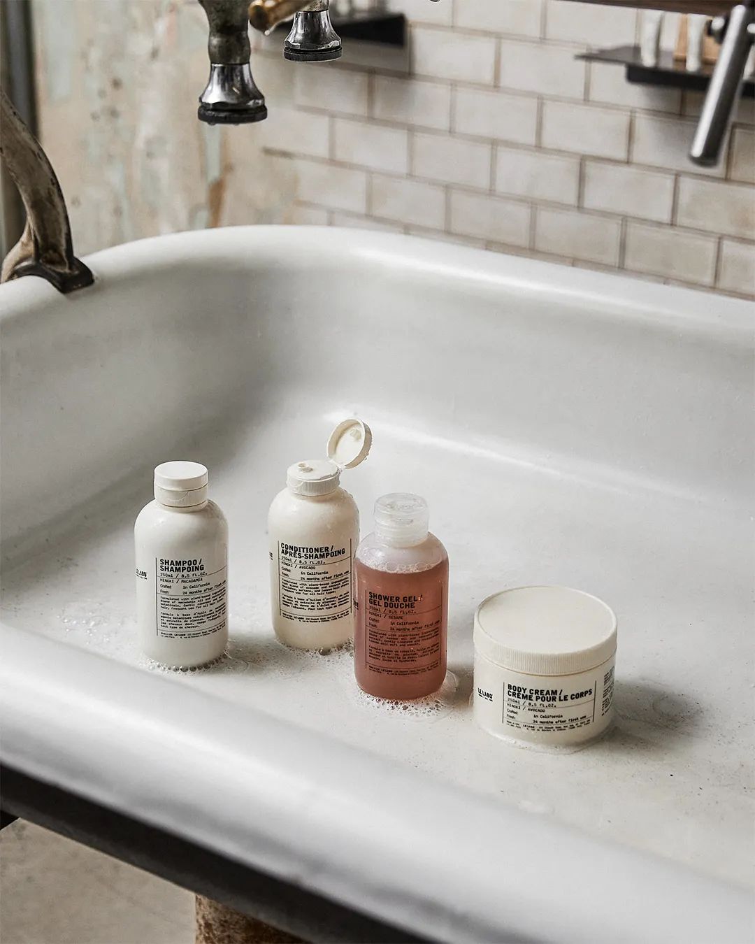 le labo store Four bottles of different sizes on a white sink
