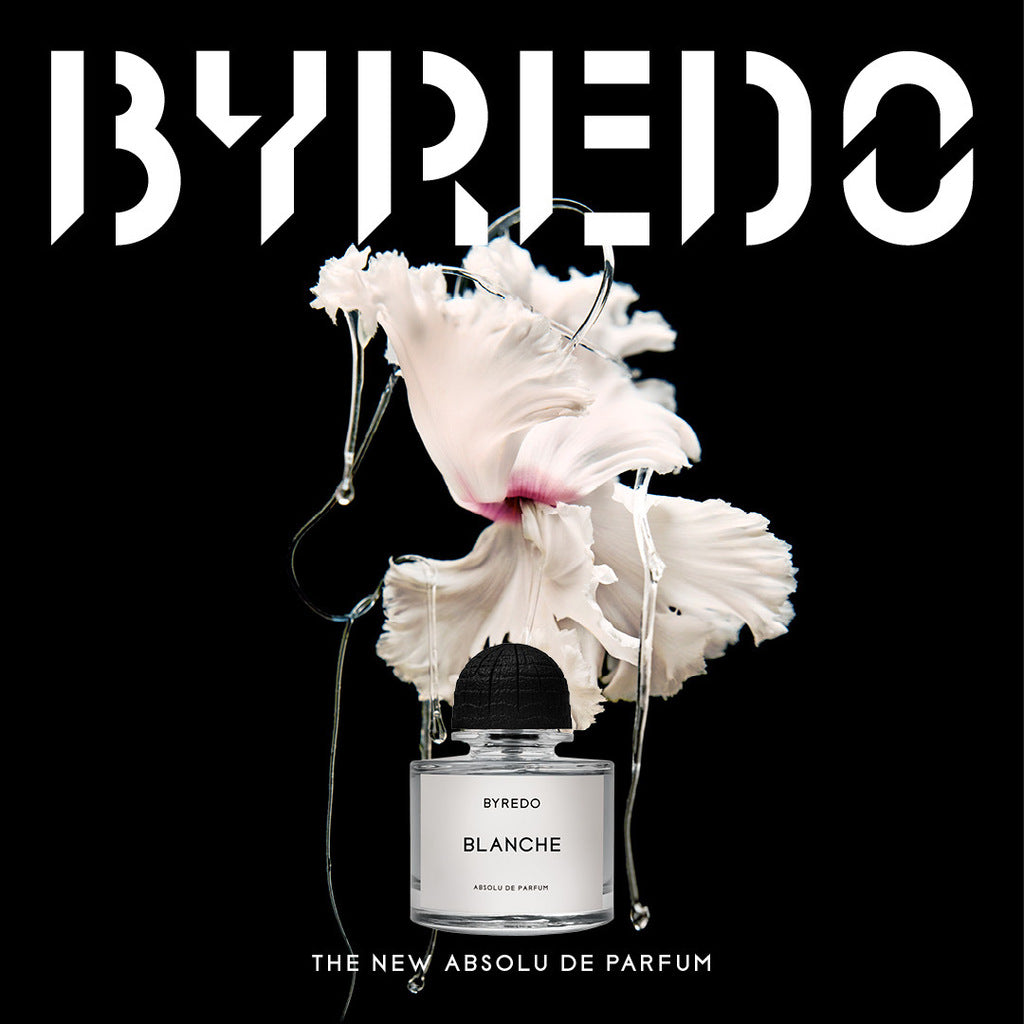 Byredo Blanche perfume bottle with white flowers on a black background