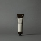 Le Labo Hand cream tube labeled 'Santal 33' on a gray background
