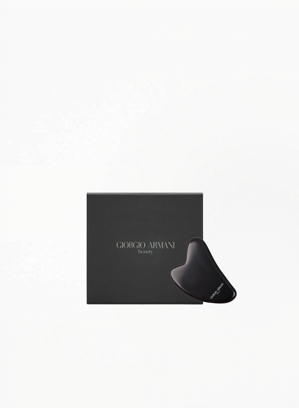 Giorgio Armani facial massage stone in black with branded Armani Beauty box, displayed on a clean white background.
