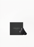 Giorgio Armani facial massage stone in black with branded Armani Beauty box, displayed on a clean white background.
