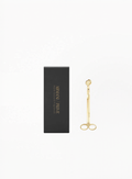 Gold Armani Privé candle wick cutter with branded black packaging on a white background.

