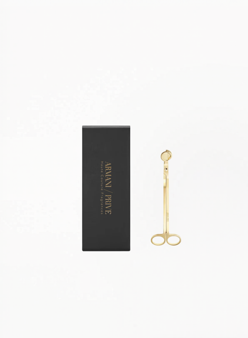 Gold Armani Privé candle wick cutter with branded black packaging on a white background.
