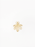 Guerlain gold bee brooch with sculpted striped details, presented on a clean minimalist background with elegant luxury accessory styling and authentic Guerlain-inspired design.