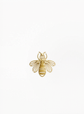 Guerlain gold bee charm, brooch with crystal details, displayed on a clean elegant background featuring refined luxury accessory craftsmanship and authentic decorative design at Exquisite.