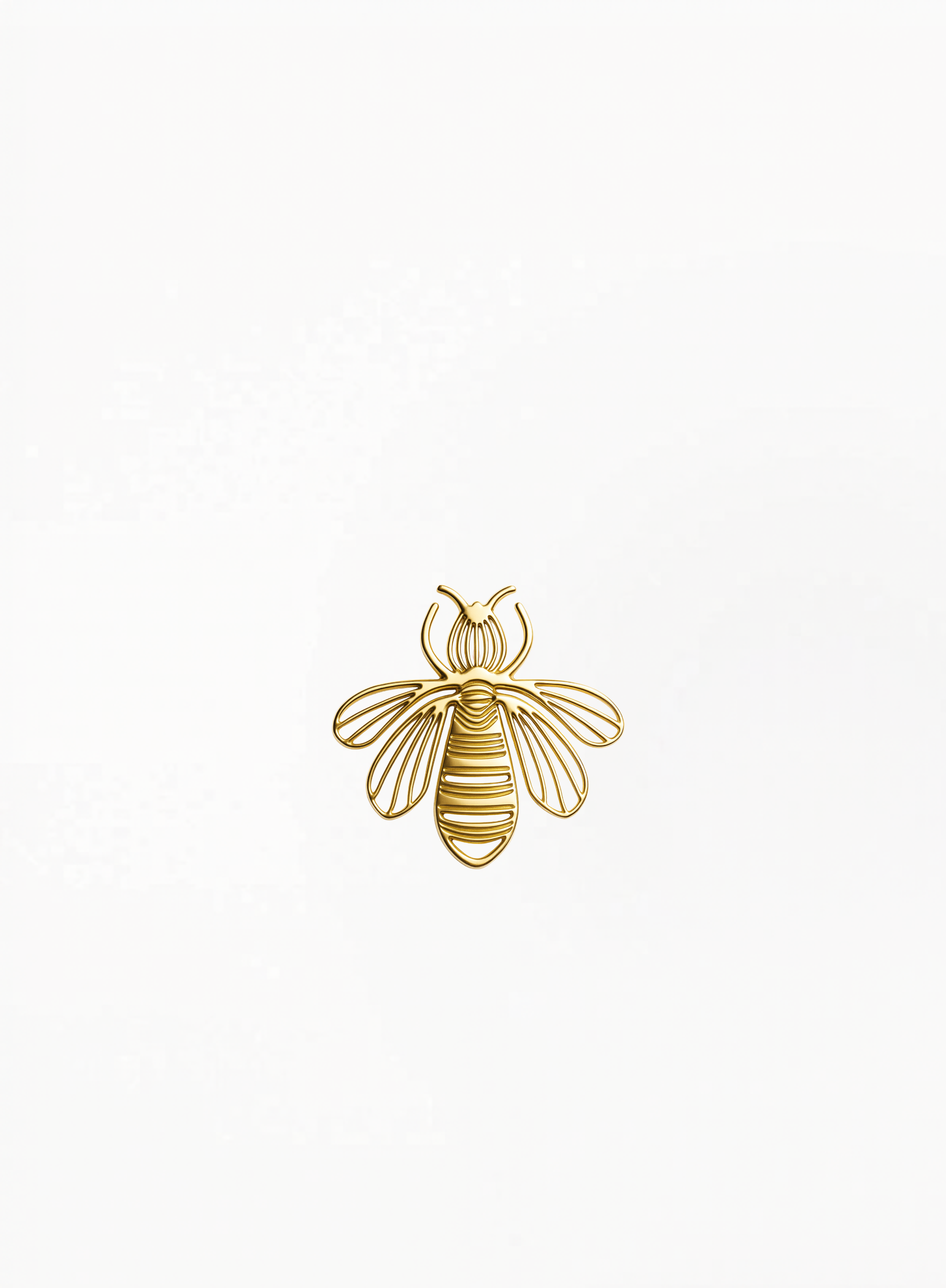 Guerlain gold bee charm, brooch with crystal details, displayed on a clean elegant background featuring refined luxury accessory craftsmanship and authentic decorative design at Exquisite.