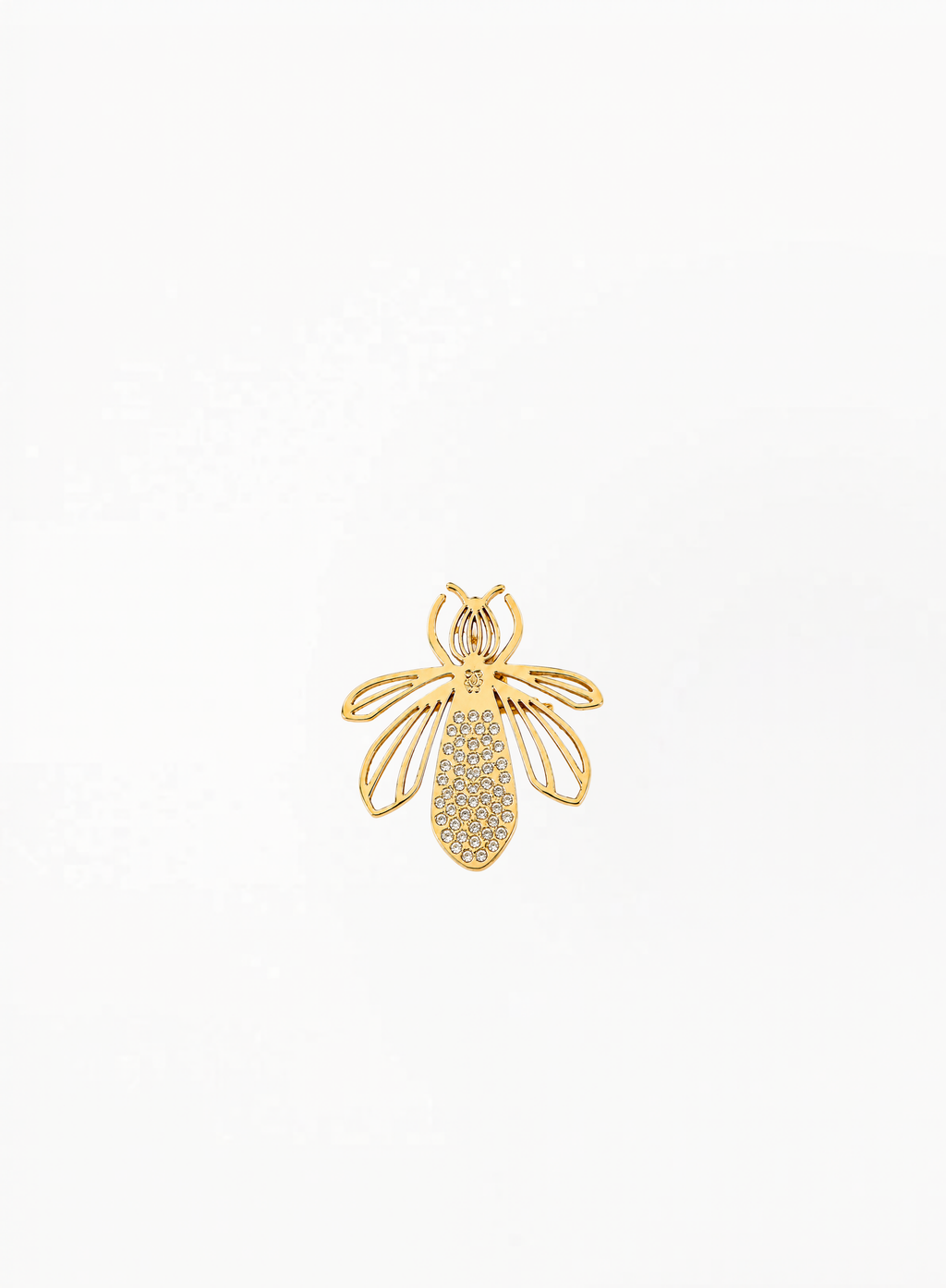 Guerlain gold bee charm, brooch with openwork wing details, displayed on a clean elegant background featuring refined luxury accessory craftsmanship and minimalist decorative design.