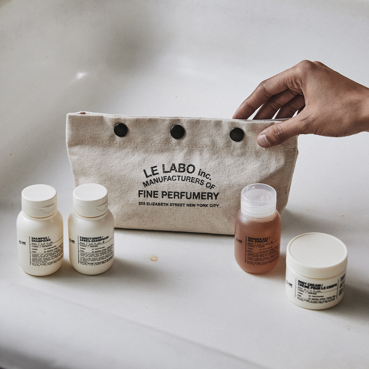 Le Labo Hinoki travel set with shampoo, conditioner, shower gel and body cream, authentic luxury travel care set available at Exquisite.