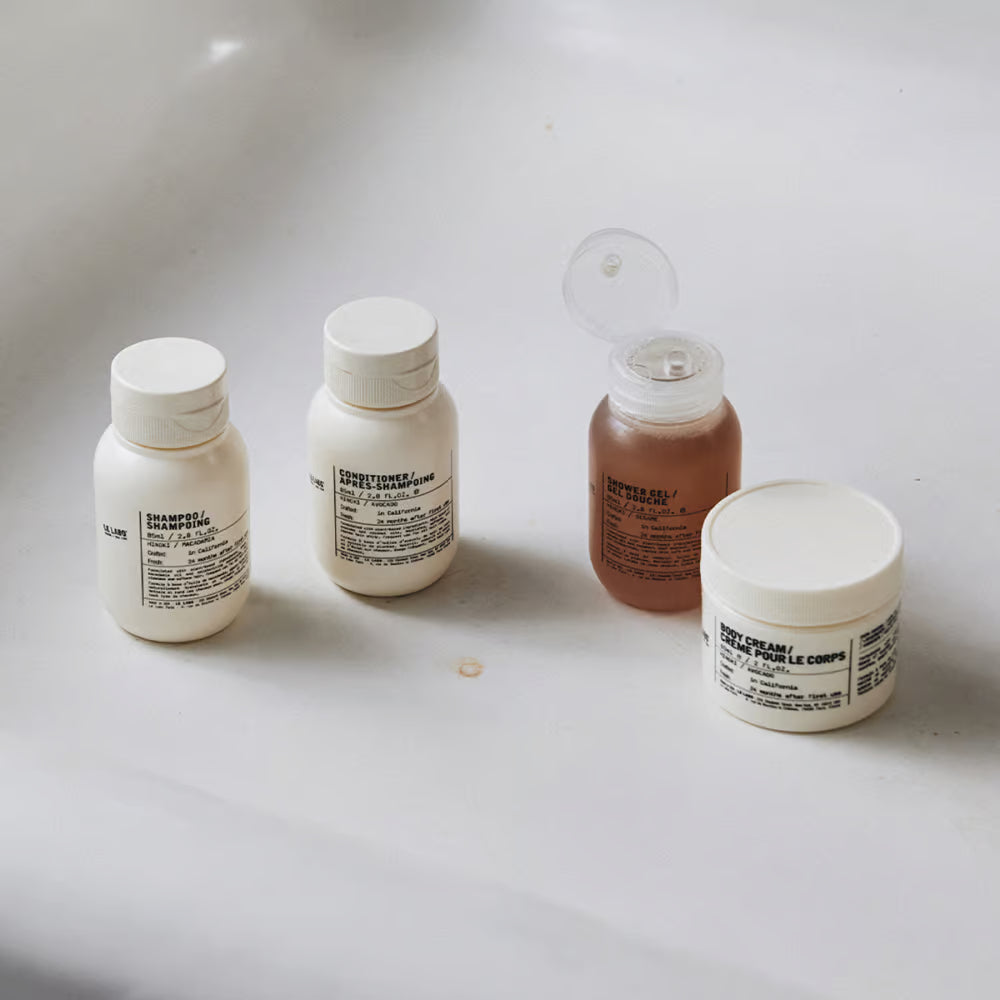 Le Labo Hinoki travel set with shampoo, conditioner, shower gel and body cream, authentic luxury travel care set available at Exquisite.