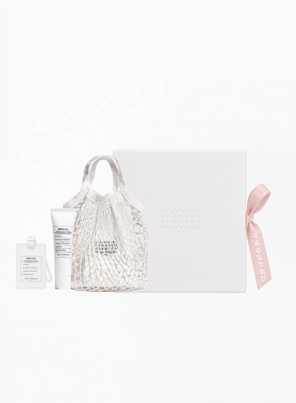 Maison Margiela Petite Mesh Tote 25x25cm with Sailing Day Hand Cream 15ML and white Replica luggage tag, authentic Maison Margiela accessories and body care set available at Exquisite.