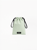 Prada Beauty neon green drawstring pouch with black logo print and soft fabric texture on white background.