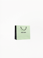 Prada Paper Bag gift packaging with elegant branded design, photographed on a clean white background for Exquisite.