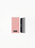 Prada black comb presented inside a pink Prada case, displayed on a clean elegant background featuring authentic Prada luxury accessory design and refined minimalist details.