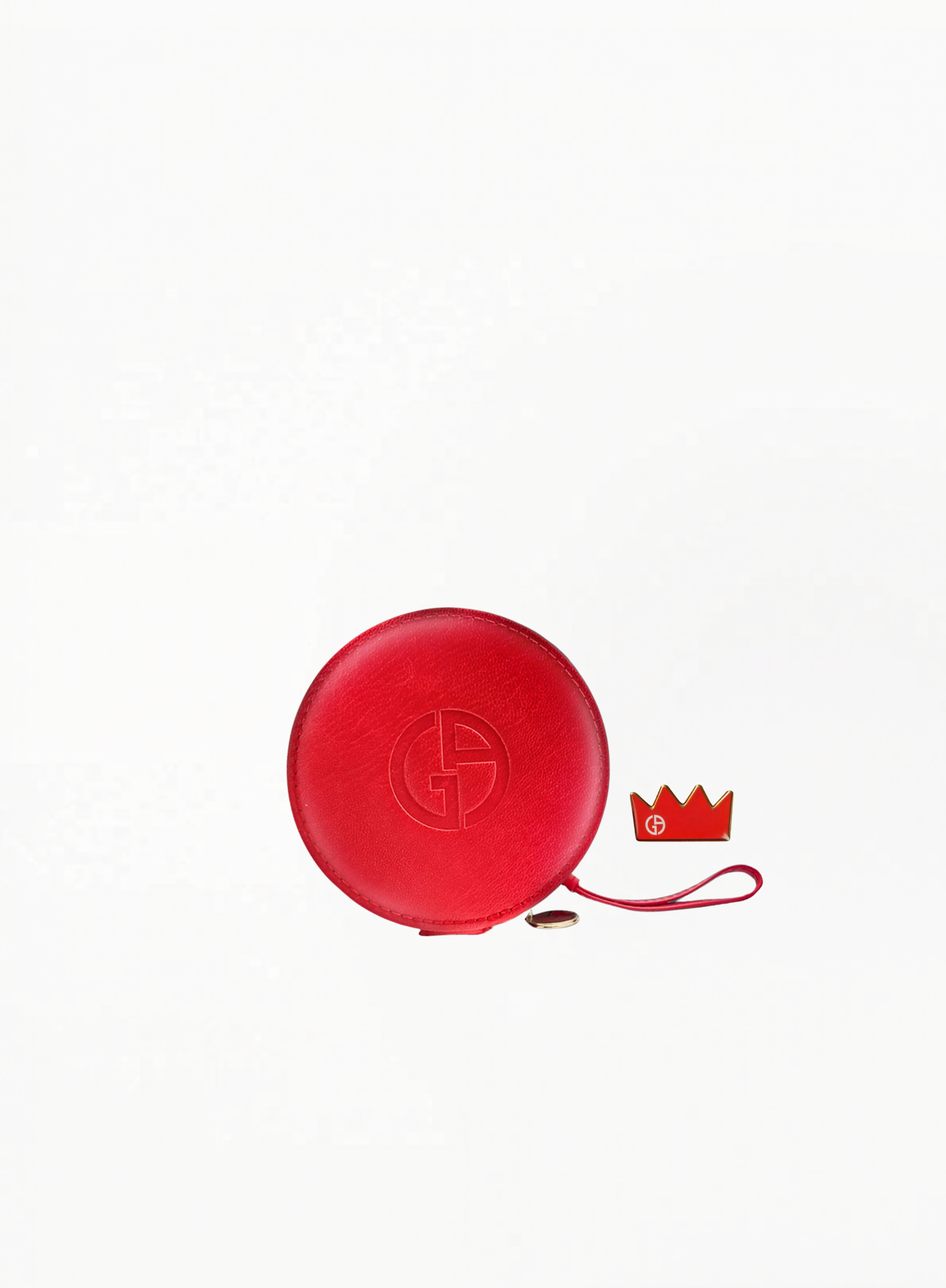 Red Giorgio Armani round cosmetic pouch with embossed logo and attached charm on a white background.
