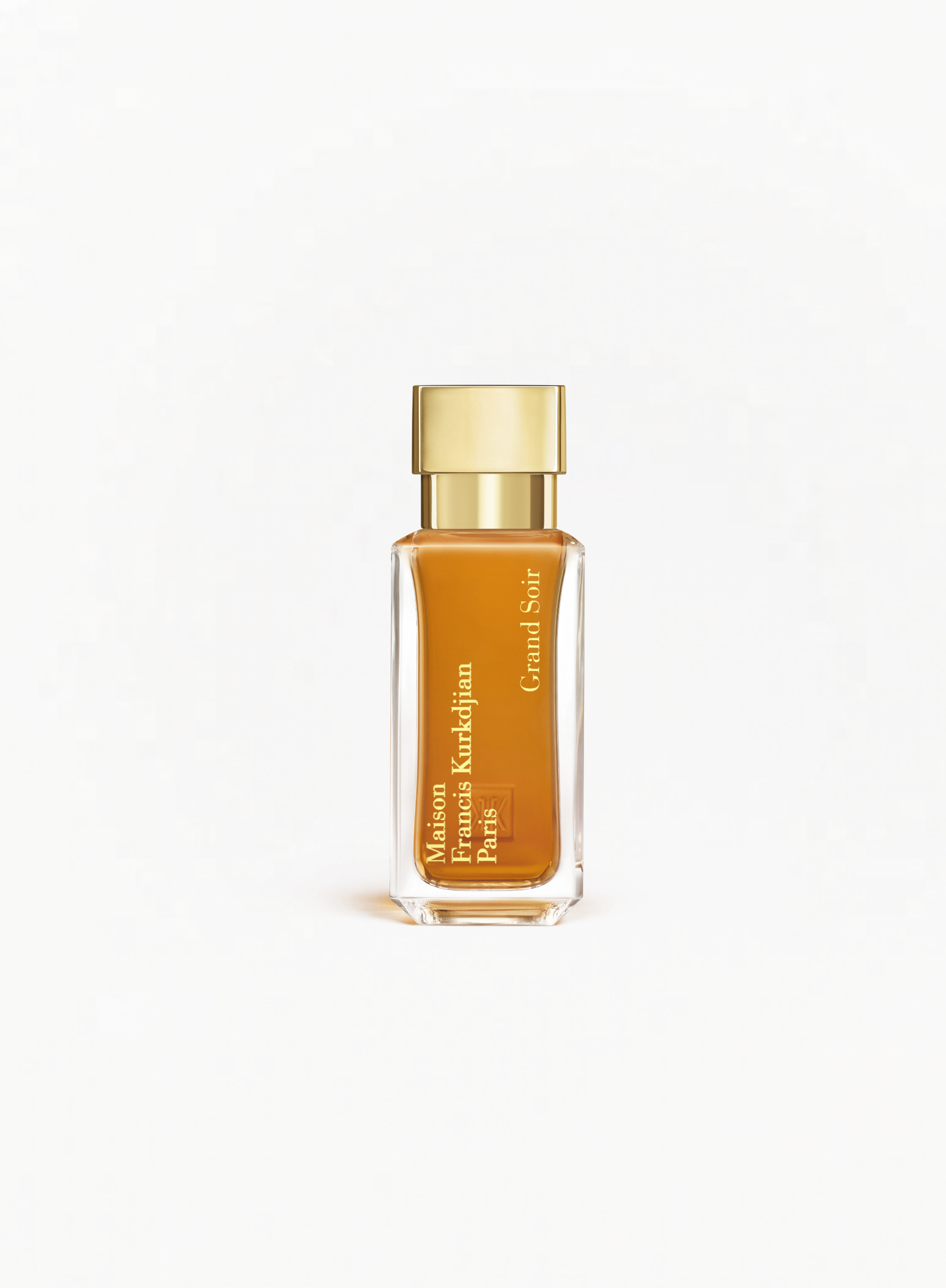 MAISON FRANCIS KURKDJIAN Grand Soir Eau de Parfum 35ml bottle with a gold cap and amber-colored fragrance on a white background.