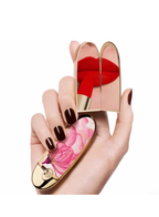 Guerlain Rouge G lipstick case Cherry Petal with pink floral design held in hand on white background