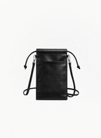 Maison Margiela black leather-effect tote bag featuring a monochromatic design, matching black drawstring closure, and a slim black crossbody strap with silver-tone hardware against a plain white background. The front showcases the brand's signature numeric logo subtly embossed in black, with the number 3 circled.