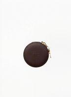 Tom Ford round leather-effect pouch with elegant luxury finish and compact silhouette, photographed on a clean background. Authentic Tom Ford accessory available at Exquisite.