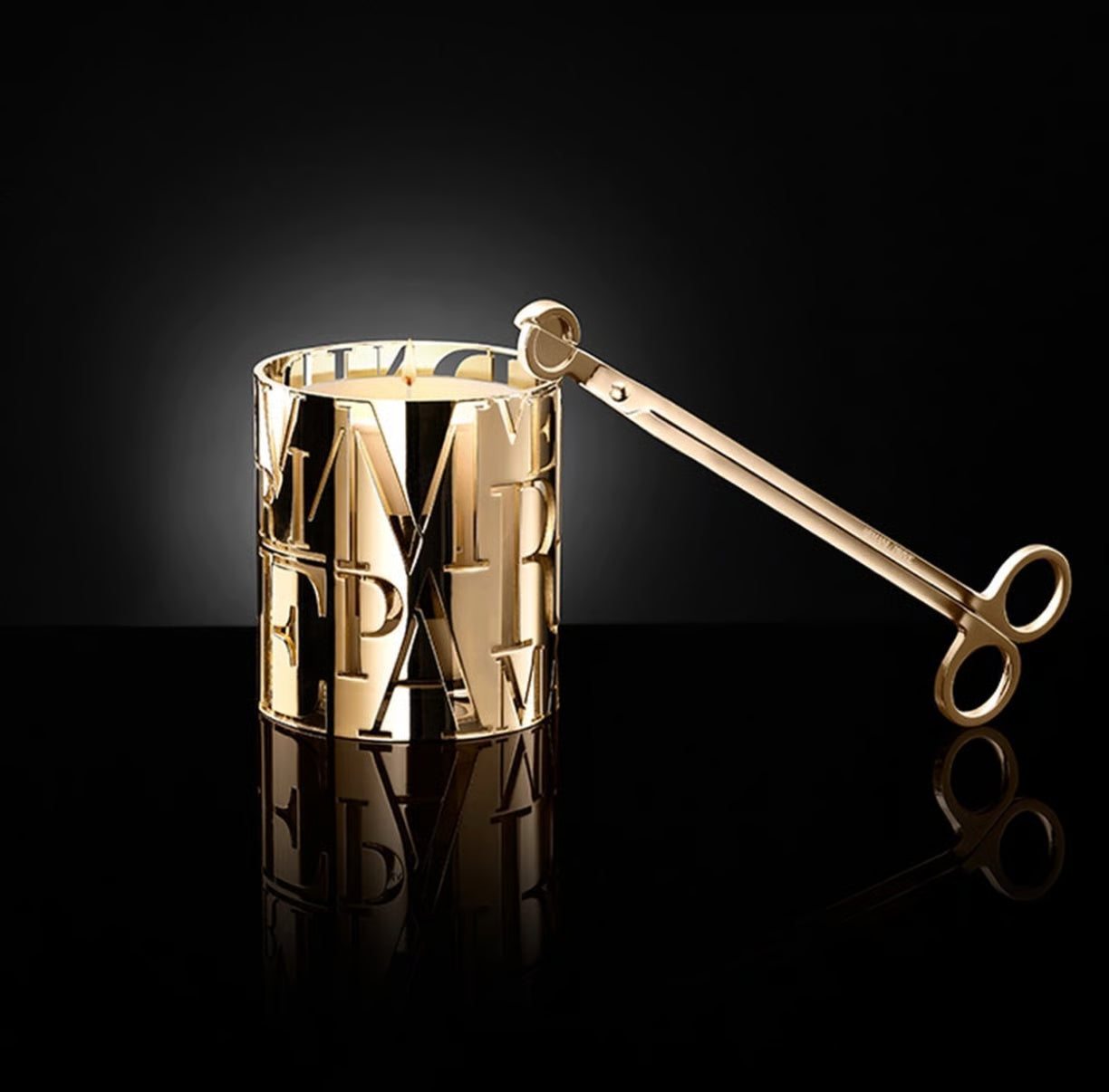armani prive candle holder Gold candle holder with lettering on a black background