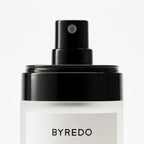 Byredo body mist bottle with black spray top on a white background