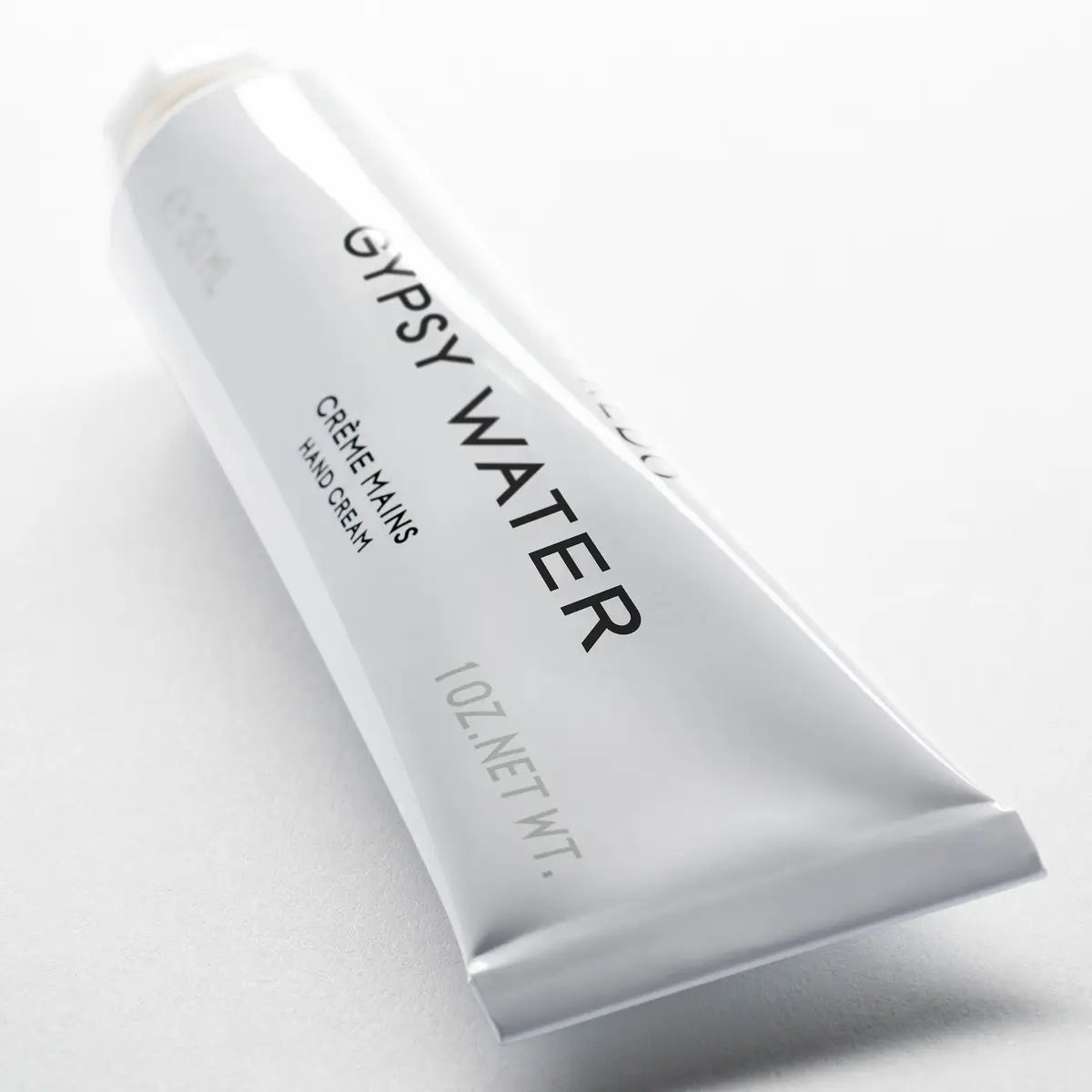 Gypsy Water hand cream tube on a light gray background