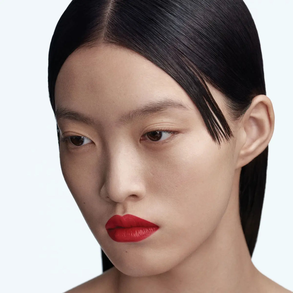 Model wearing Byredo Matte Lipstick Eperdu 224 elegant matte red tone
